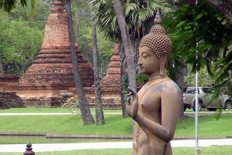 Because it is so photogenic, yet another Image of the Walking Buddha at Wat Sa Si. The stupas in the background