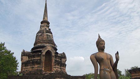 A small stupa with a Walking Buddha Image at Wat Sa Si, Sukhothai.