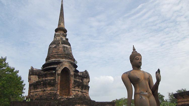 A small stupa and the Image of a Walking Budda at Wat Sa Si, Sukhothai.